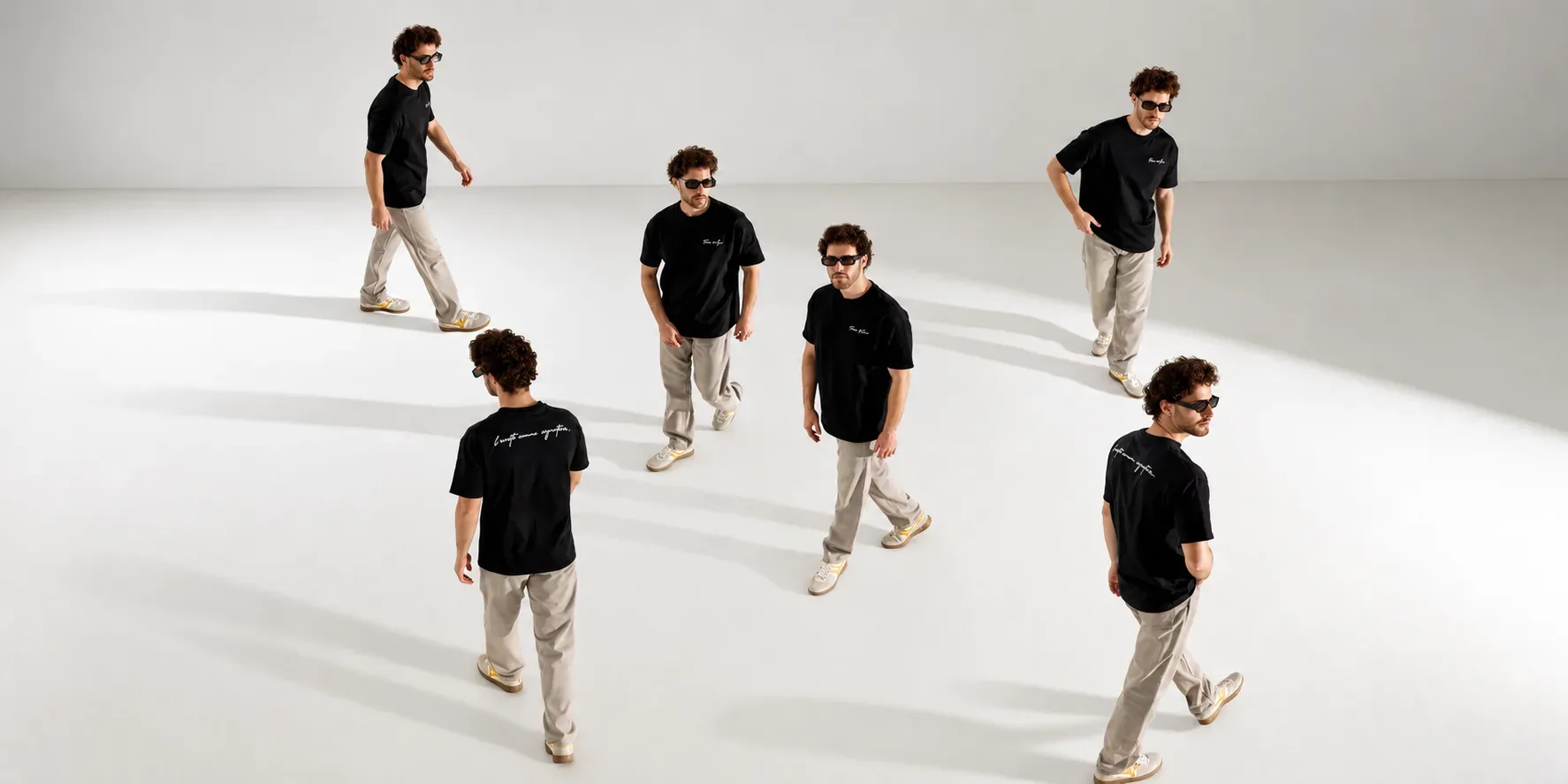 The Frères et Sœur family walking in the studio in black oversized tees